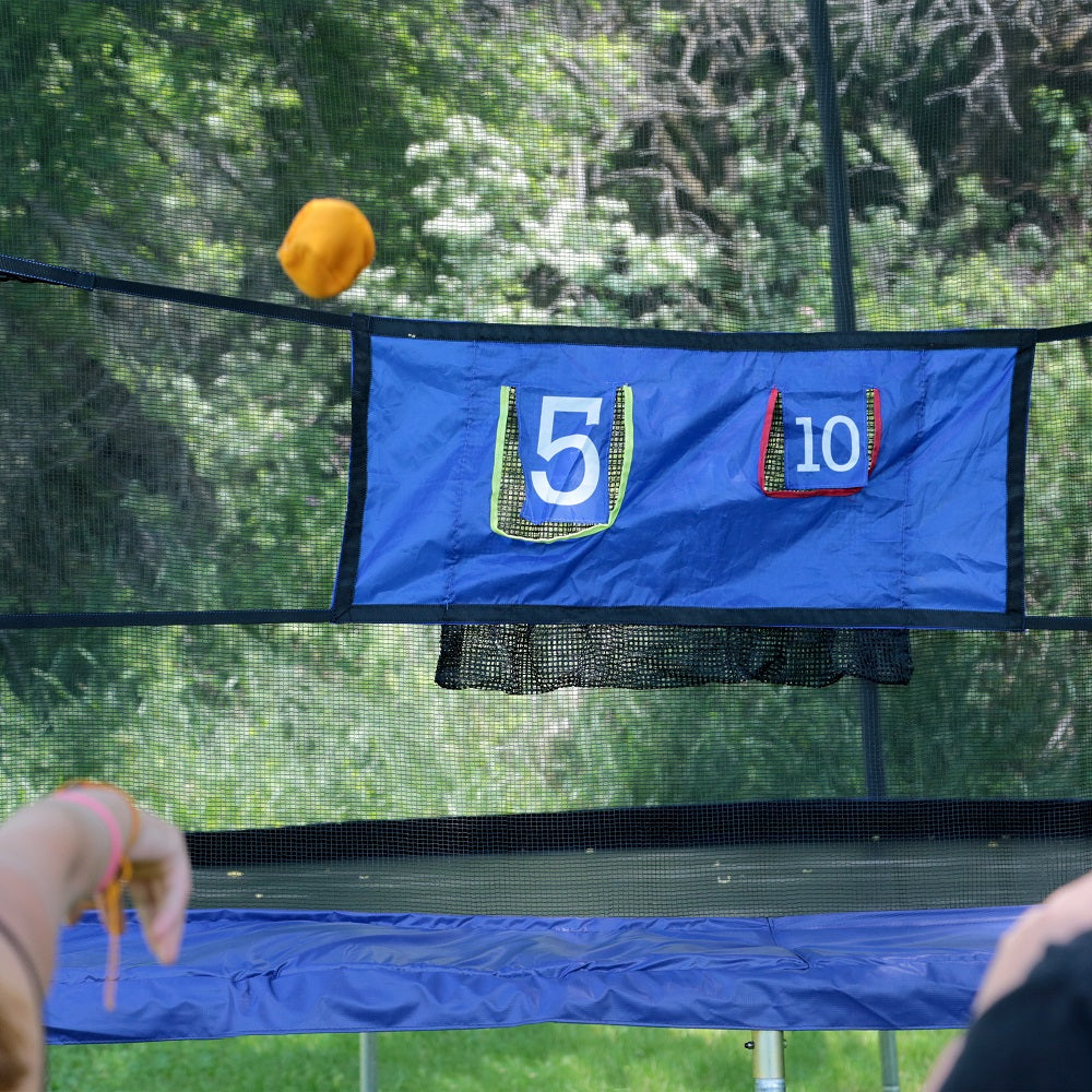 A yellow bean bag is being thrown at the Double Toss game. 